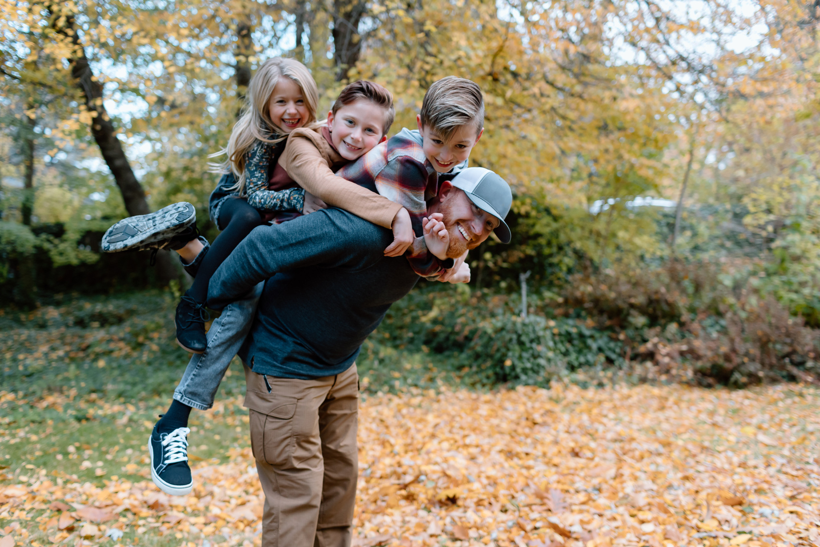 Dad with three kids playing outside