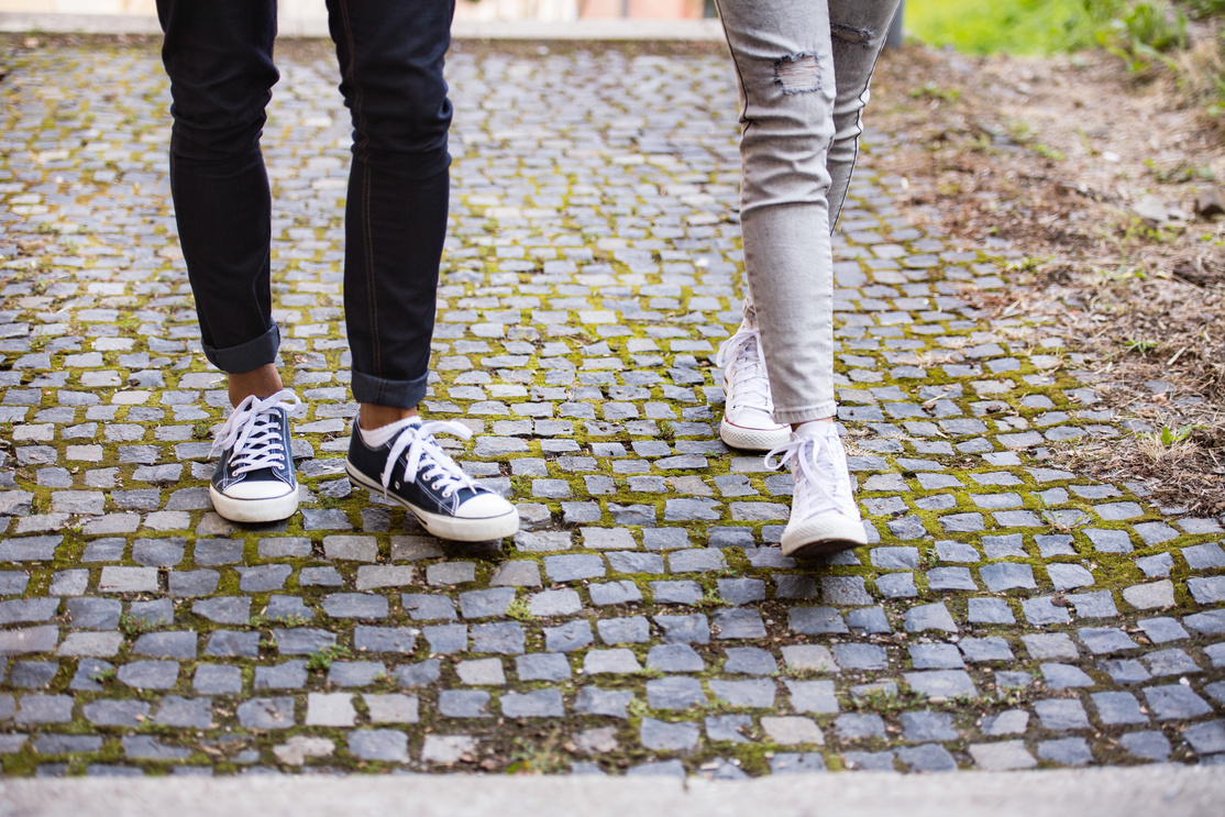 Legs of Two Unrecognizable Young Tourists in Old Town.